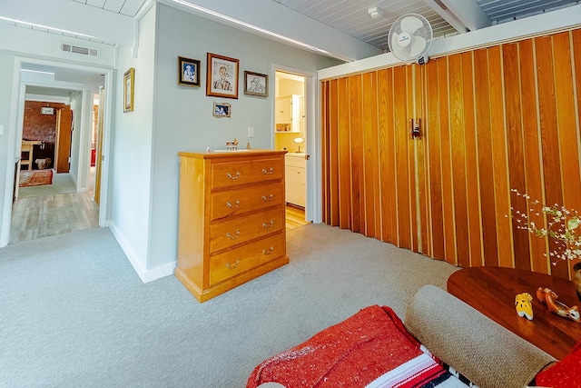 220 Belmont Rd Unit 3, Tallahassee, FL 32301 - sitting room featuring light colored carpet, beamed ceiling, and wooden walls