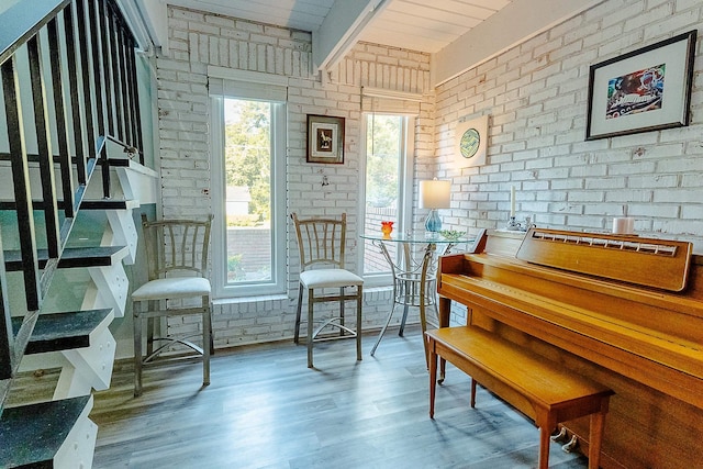220 Belmont Rd Unit 3, Tallahassee, FL 32301 - living area featuring brick wall, healthy amount of natural light, wood finished floors, and stairway