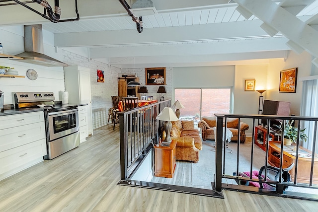 220 Belmont Rd Unit 3, Tallahassee, FL 32301 - kitchen featuring stainless steel range with electric cooktop, wall chimney range hood, beam ceiling, light wood-style flooring, and open shelves