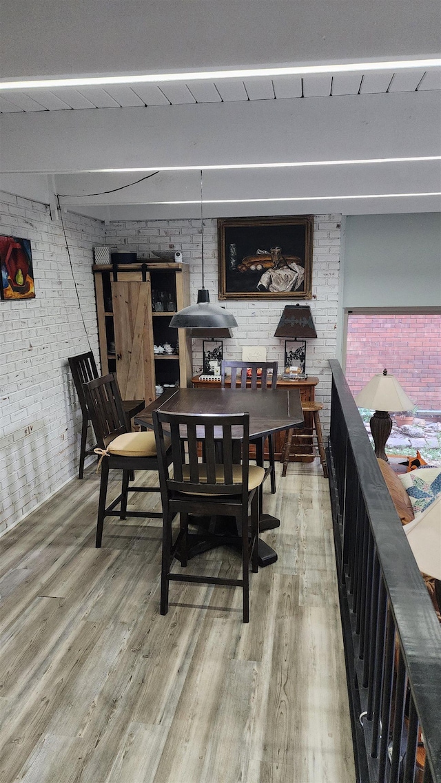 220 Belmont Rd Unit 3, Tallahassee, FL 32301 - dining space with brick wall and light wood-type flooring