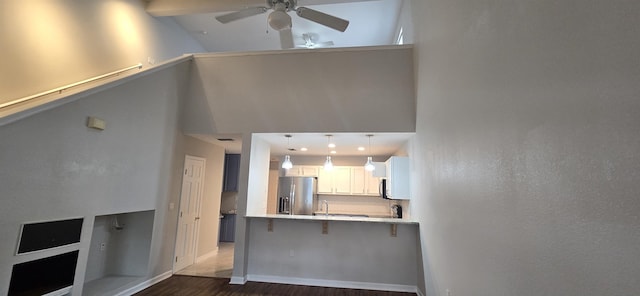 unfurnished living room featuring ceiling fan, high vaulted ceiling, and dark hardwood / wood-style floors