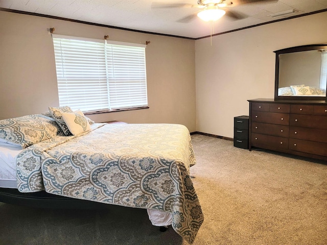 bedroom with light carpet, ceiling fan, and crown molding