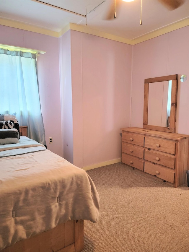 bedroom with ceiling fan, ornamental molding, and carpet flooring