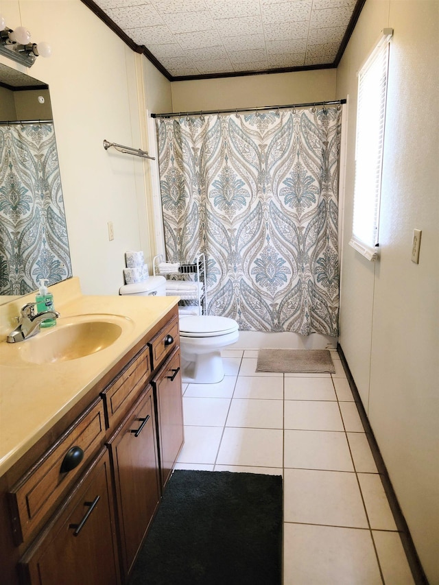 bathroom with a healthy amount of sunlight, crown molding, vanity, and toilet