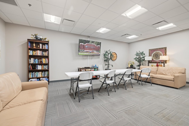 office area with carpet, a paneled ceiling, and baseboards