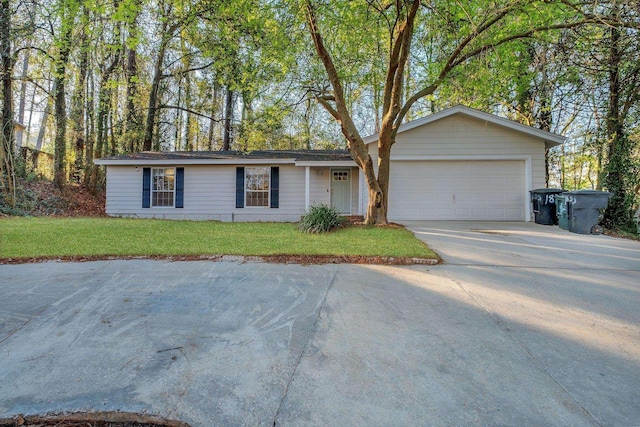 ranch-style house featuring a garage, a front lawn, and driveway