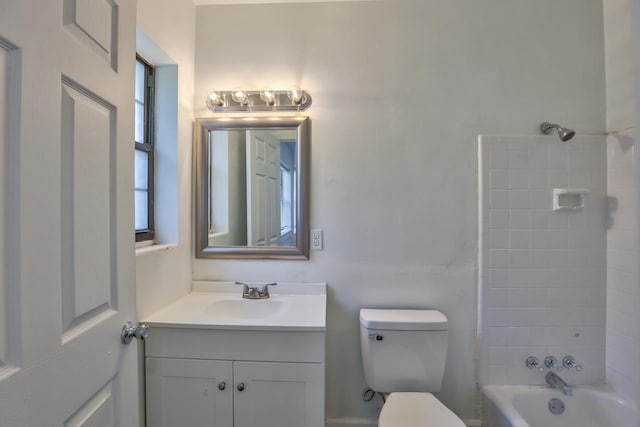 full bathroom with vanity, toilet, and tiled shower / bath