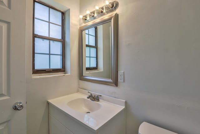 bathroom featuring toilet and vanity