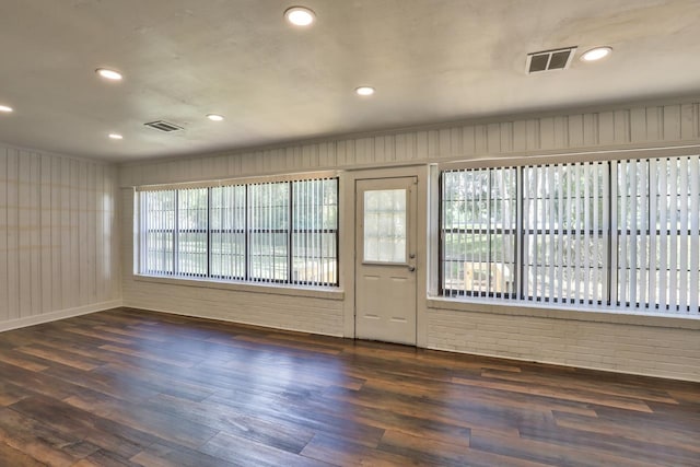 entryway with a wealth of natural light and dark hardwood / wood-style floors