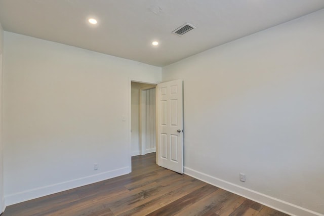 unfurnished room with dark wood-type flooring