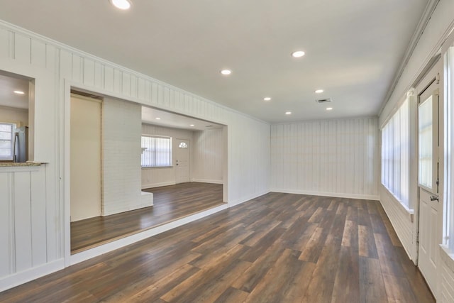 unfurnished room with crown molding and dark hardwood / wood-style flooring