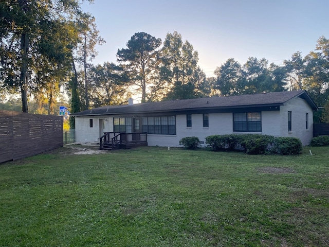 back house at dusk with a yard