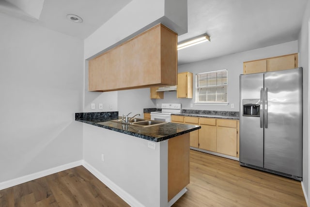 kitchen with kitchen peninsula, stainless steel fridge, white electric range, sink, and light brown cabinets