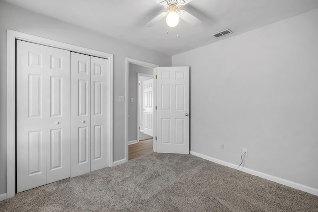 unfurnished bedroom with carpet floors, a closet, and ceiling fan