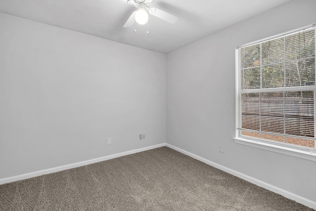 spare room featuring carpet floors, ceiling fan, and a healthy amount of sunlight