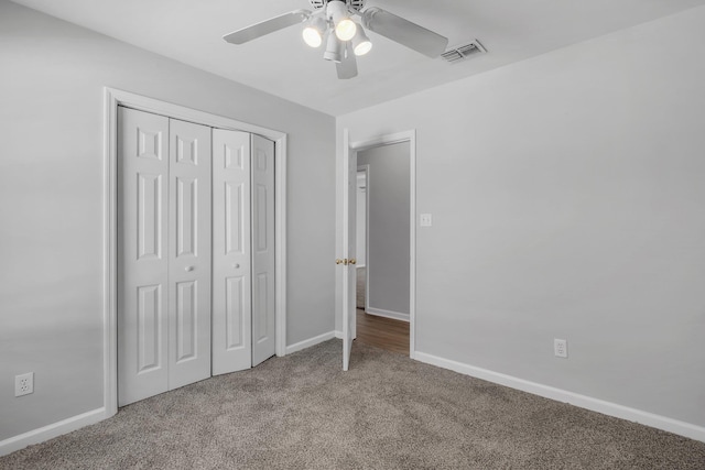 unfurnished bedroom with carpet floors, a closet, and ceiling fan