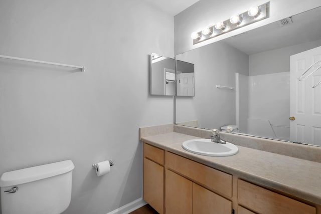 bathroom with toilet and vanity