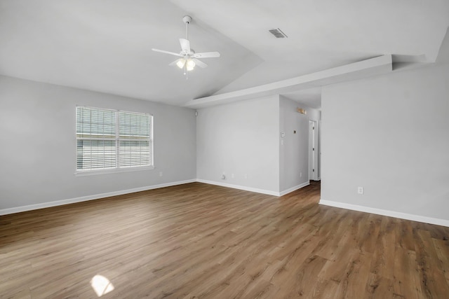 spare room featuring ceiling fan, light wood-type flooring, and vaulted ceiling