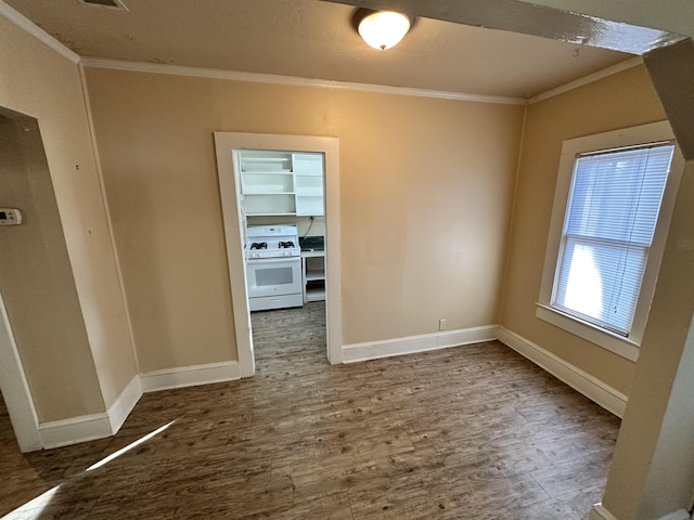 spare room with wood-type flooring and ornamental molding