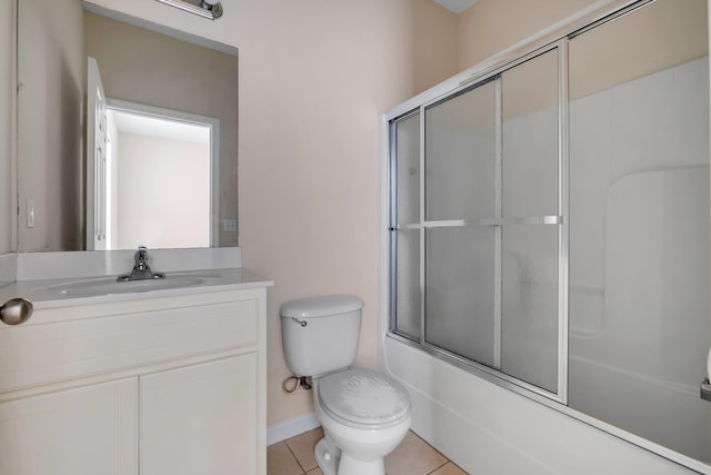 full bathroom with tile patterned floors, toilet, vanity, and bath / shower combo with glass door