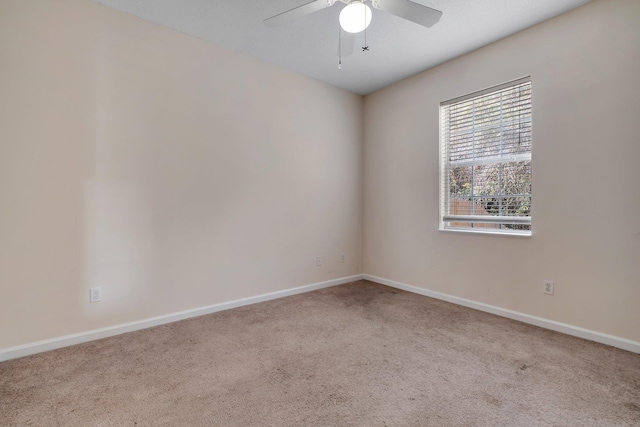 carpeted empty room featuring ceiling fan