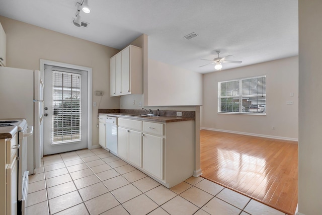 kitchen featuring white cabinetry, white appliances, light tile patterned flooring, and plenty of natural light