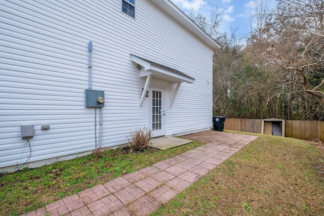 view of property exterior featuring a storage unit and a yard