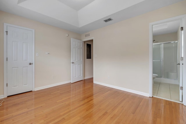 unfurnished bedroom featuring light hardwood / wood-style flooring and ensuite bathroom