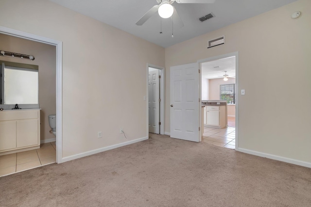 unfurnished bedroom with sink, connected bathroom, and light colored carpet