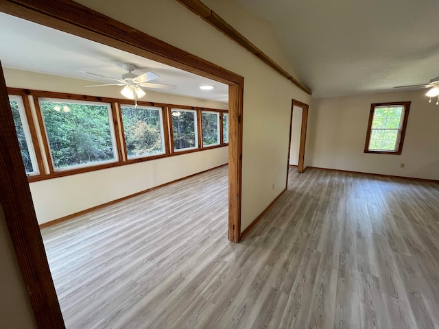 unfurnished living room with vaulted ceiling, ceiling fan, and light hardwood / wood-style flooring