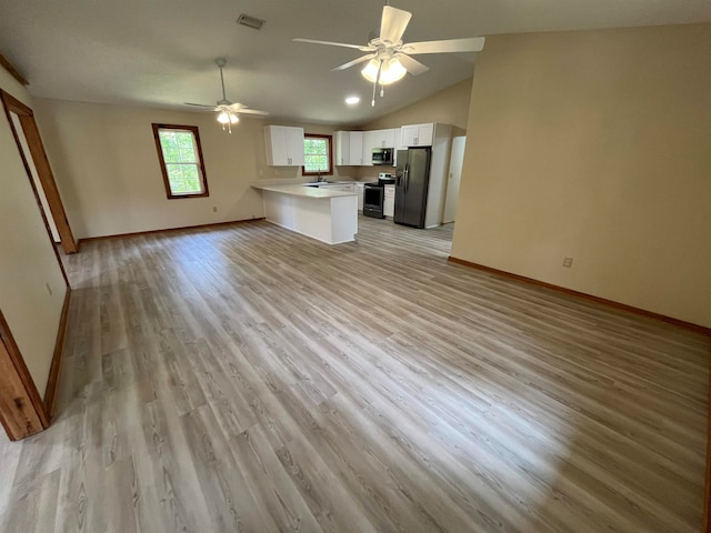 kitchen featuring stainless steel appliances, light hardwood / wood-style floors, white cabinetry, ceiling fan, and lofted ceiling