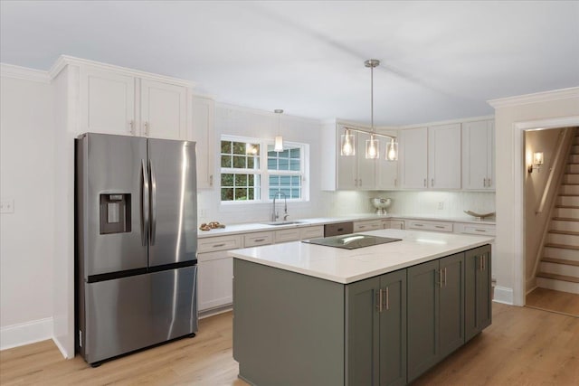 kitchen with sink, light hardwood / wood-style flooring, white cabinets, a kitchen island, and stainless steel fridge with ice dispenser