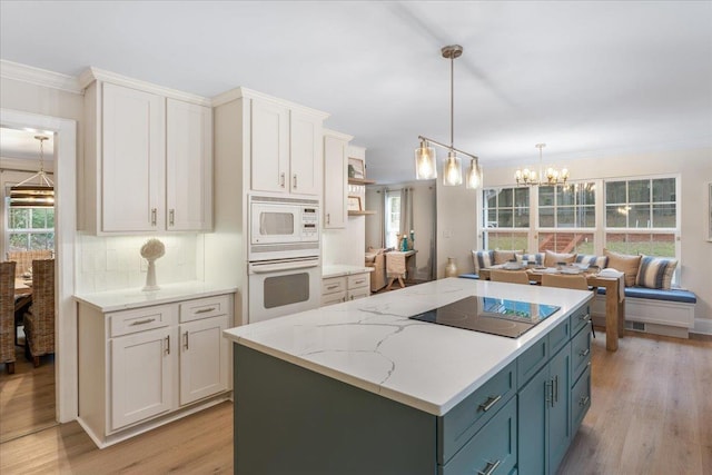 kitchen with white cabinets, decorative backsplash, ornamental molding, white appliances, and light hardwood / wood-style flooring