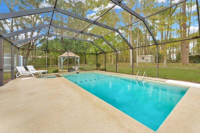 view of swimming pool featuring a storage shed, a patio area, a gazebo, glass enclosure, and a lawn