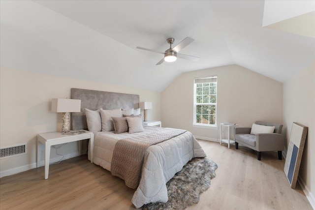 bedroom featuring lofted ceiling, light hardwood / wood-style flooring, and ceiling fan