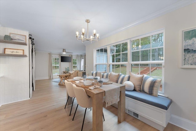 dining space featuring crown molding, ceiling fan with notable chandelier, and light hardwood / wood-style floors