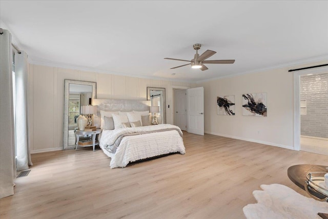 bedroom with crown molding, ensuite bath, ceiling fan, and light hardwood / wood-style floors