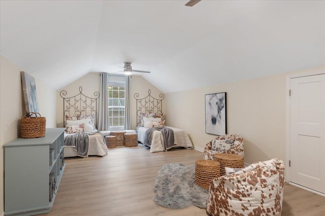 bedroom featuring vaulted ceiling, light wood-type flooring, and ceiling fan