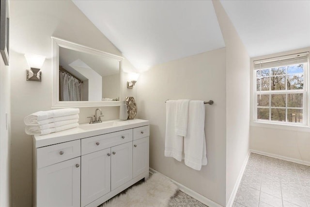 bathroom with vanity and vaulted ceiling