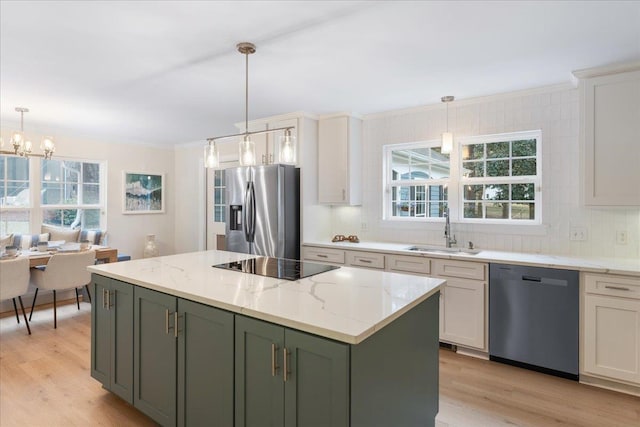 kitchen with white cabinets, a center island, sink, and black appliances