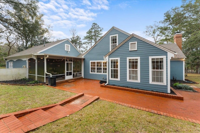 back of property featuring a sunroom, a yard, and a patio area