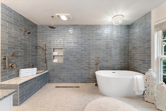 bathroom with tile walls, vanity, and plus walk in shower