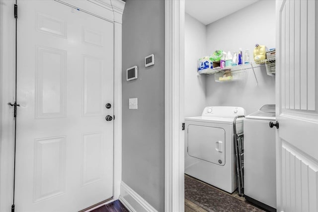 washroom with laundry area, baseboards, and separate washer and dryer