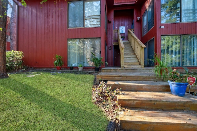 property entrance with a lawn