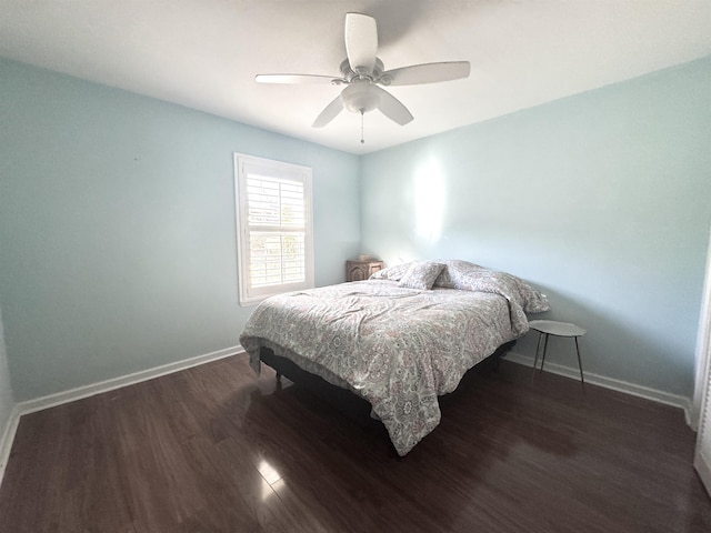 bedroom featuring ceiling fan, wood finished floors, and baseboards