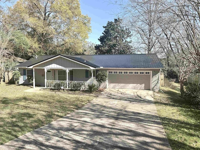 single story home featuring a garage, brick siding, concrete driveway, a porch, and a front yard