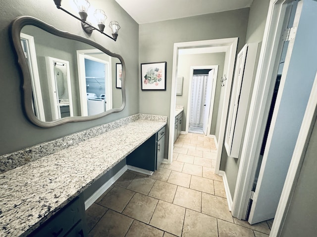 bathroom featuring tile patterned flooring, baseboards, and vanity