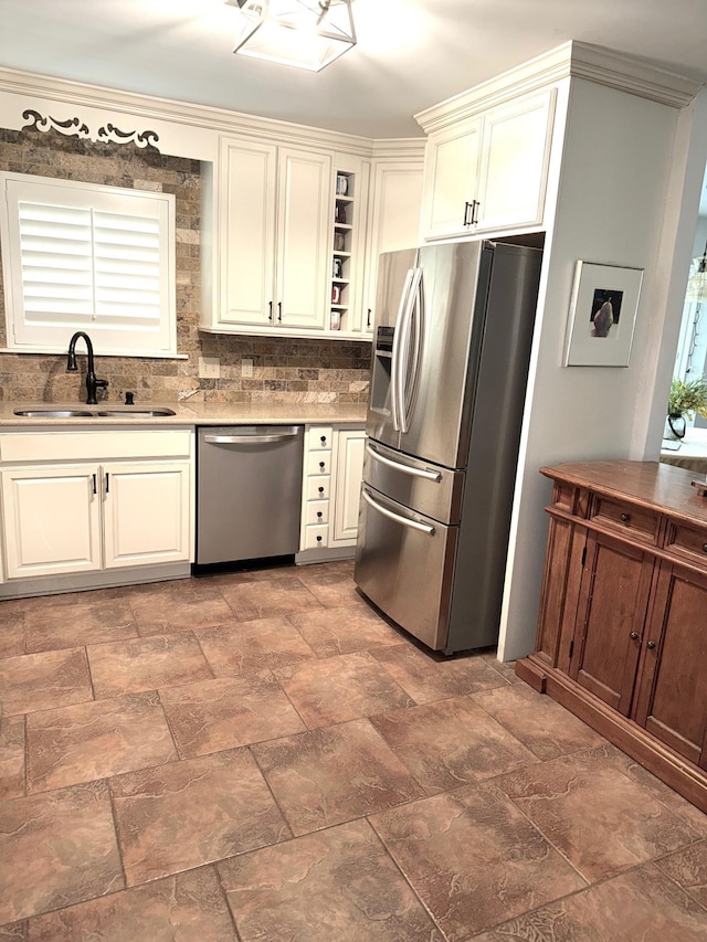 kitchen with tasteful backsplash, stone finish flooring, stainless steel appliances, open shelves, and a sink