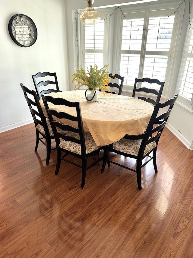 dining area featuring wood finished floors and baseboards