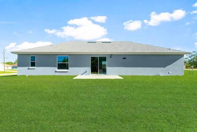 rear view of property featuring a yard